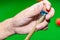 Close up hand player snooker using chalk rubbing a cue