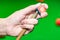 Close up hand player snooker using chalk rubbing a cue