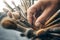 Close up of a hand reaching for a paintbrush