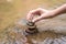 Close up hand to doing Stone stacked in water river