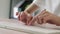 Close up of hand typing on the computer keyboard, on wooden desk