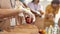 Close up of hand of volunteer in glove holding an apple while collecting, sorting food for needy people in paper bags