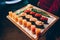 Close-up Hand Waiter holding Set Delicious fresh Sushi slate plate Sushi Rolls Warm Sake Unagi, Japanese raw fish in traditional