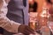 Close up of hand of waiter serving a bottle