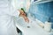 Close-up of hand washing. Woman in a bathrobe washes her hands while standing next to the wash basin in the bathroom