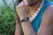 close up of a hand wearing macrame style bracelet with moon stone