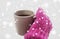 Close up of hand in winter mitten holding tea mug