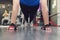 Close up hand of woman doing push ups in the gym. Training girls in the hall. Gloved hands on the floor in close-up. mitaines