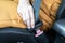 Close up hand of woman fasten seat belts before diving car for protection and safety