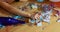 Close up of hand woman hold a glass of champagne, sleeping at table in messy room