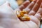 Close up hand of woman overdosing on medication.