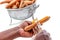 Close up Hand of woman peel carrots with a knife in the kitchen room on white