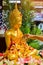 Close up hand of woman sprinkle water onto a gold buddha image on Songkran Festival Day at Thailand