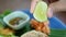 Close up hand of Woman squeezing limes on pork fried rice ready to eat. Thai style cuisine.