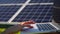 Close-up: hand woman used laptop in her hands standing on field with solar panels