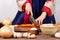 Close up hand woman wearing hanbok cutting vegetable with knife on table preparing cook kimchi traditional food in kitchen copy