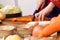 Close up hand woman wearing hanbok cutting vegetable with knife on table preparing cook kimchi traditional food in kitchen copy