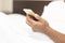 Close up hand young man cell phone addict man awake at morning in bed