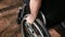 Close up, hand of young woman steering the wheel of the wheelchair.