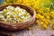 close-up of a handcrafted basket filled with dried chamomile flowers