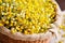 close-up of a handcrafted basket filled with dried chamomile flowers