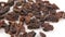 Close-up a handful of sweet raisins rotate on a white background.Sweet organic raisins rotate on a plate.