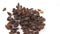 Close-up a handful of sweet raisins rotate on a white background.Sweet organic raisins rotate on a plate.