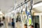 Close up of handles on ceiling standing passenger inside skytrain, Selective focus