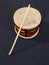 Close-up of a handmade Brazilian percussion instrument: a small drum with drumstick.