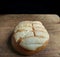 Close-up of handmade shell bread on wooden board with black background. typical mexican bread