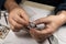 Close up hands of amateur man with age spots, holding plastic part of aircraft, assembled and painted by hand.