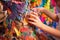 close-up of hands applying paper mache to pinata