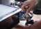 Close-up of hands barista presses ground coffee using a tamper. The process of making coffee step by step