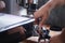 Close-up of hands barista presses ground coffee using a tamper. The process of making coffee step by step