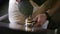 Close up hands of barista pressing ground coffee