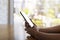 Close up hands of beautiful young woman holding mobile, smart phone sitting in cafe. Soft focus hands of women holding and use