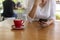 Close up hands of beautiful young woman holding mobile, smart phone sitting in cafe. Soft focus hands of women holding and use