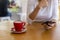 Close up hands of beautiful young woman holding mobile, smart phone sitting in cafe. Soft focus hands of women holding and use