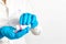 Close-up of hands in blue medical gloves holding a bottle with pills. The doctor gives a medication, vitamins and antibiotics