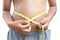 Close up hands boy measuring tape on abdominal surface