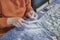 Close-up of hands of boy processing ornamental stone with file