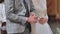 Close-up hands of the bride and groom in a Catholic church.