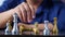 Close up of hands of a businessman moving king golden chess to surrender with an opponent the chess game is development analysis,