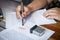 Close up hands of businessman signing and stamp on paper document to approve business investment contract agreement