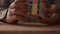 Close up hands of businessman solving rubik\'s cube puzzle on the desk.