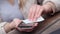 Close up on hands of caucasian young woman female holding mobile smart phone in hand wiping cleaning screen disinfection with whit