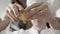 close-up of hands of a chef breaking eggs. ingredients to prepare cake. man with white chef uniform making a pie in his