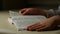 Close-up hands of child girl which lies on couch in room and reads book