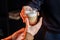 Close up of hands with coffee. Barman giving a freshly brewed  fragrant cappuccino with high milk froth in a transparent glass to