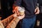 Close up of hands with coffee. Barman giving a freshly brewed  fragrant cappuccino with high milk froth in a transparent glass to